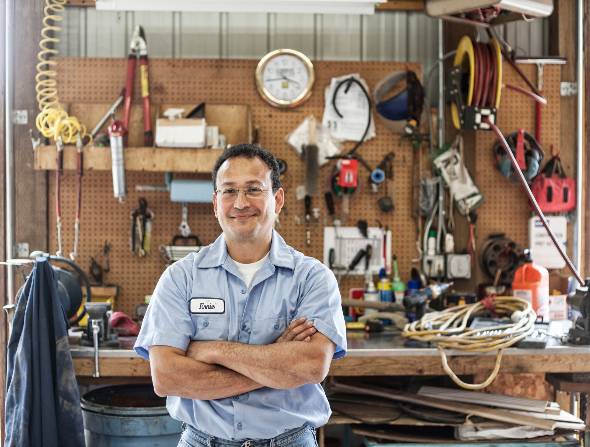 hispanic-man-worker-in-the-shop-area-of-a-landscap-2023-11-27-05-05-55-utc