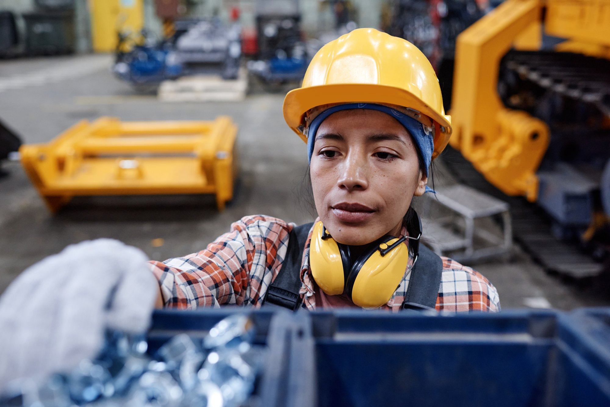 young-serious-hispanic-female-factory-worker-in-gl-2023-11-27-05-16-14-utc