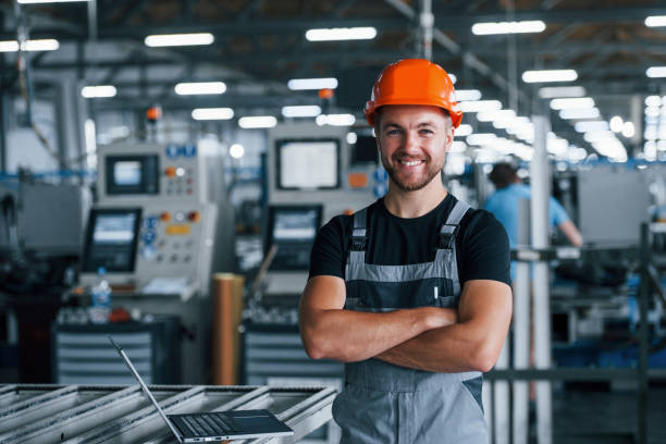 smiling-and-happy-employee-industrial-worker-indoors-in-factory-young-picture-id1186939755